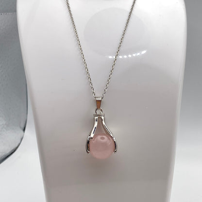 Holding Rose Quartz Crystal Pendant Necklace