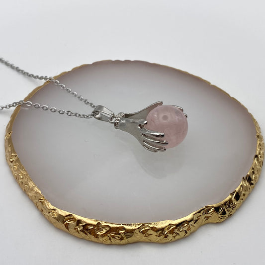 Holding Rose Quartz Crystal Pendant Necklace